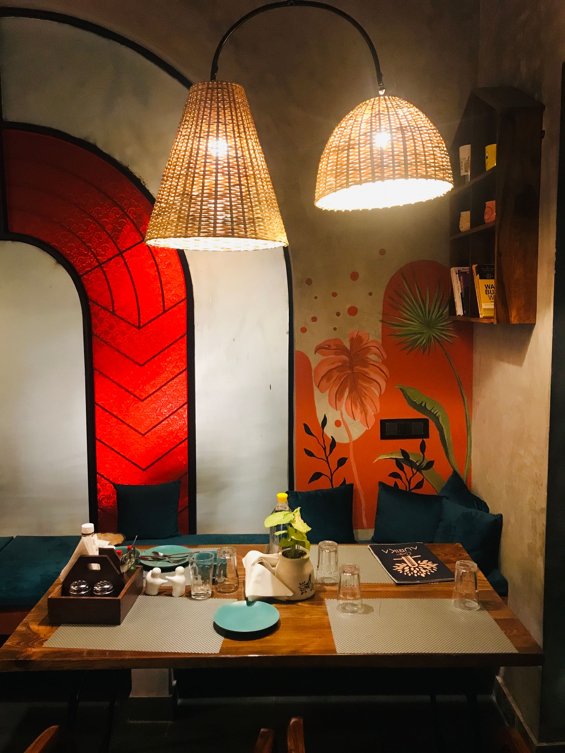 Restaurant interior with a large colourful mural covering the back wall
